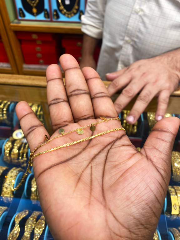 A display case showcasing an array of exquisite gold jewelry pieces at the Muttrah gold souq, Oman